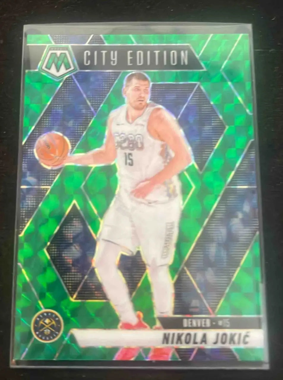 Green Panini Mosaic Nikola Jokic City Edition basketball card featuring Nikola Jokic of the Denver Nuggets