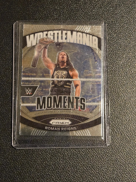 Roman Reigns Panini Prizm WWE WrestleMania Moments trading card in protective sleeve