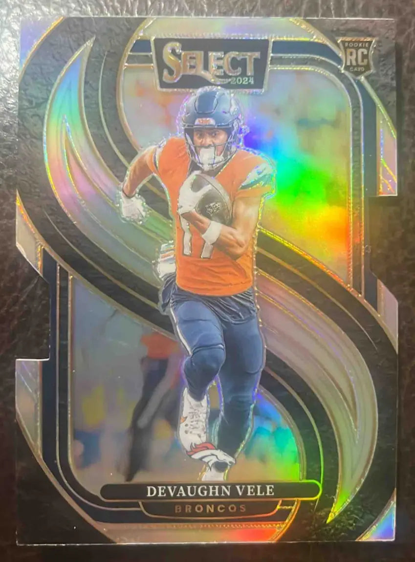 Holographic Panini Select Devaughn Vele football card from 2024 series featuring die-cut design