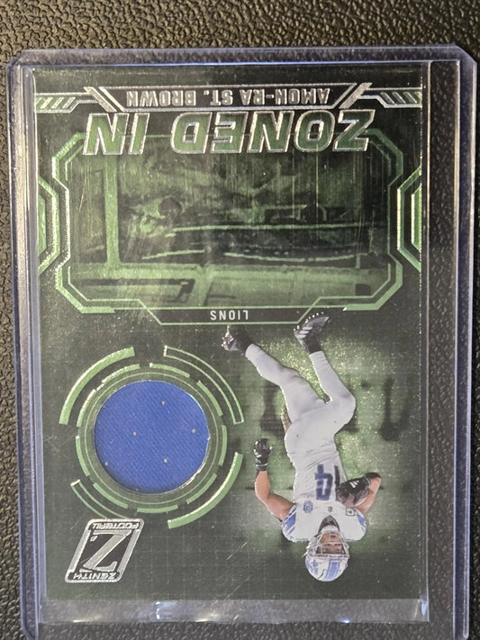 Panini Zenith Amon-Ra St. Brown Zoned In football trading card with jersey fabric swatch