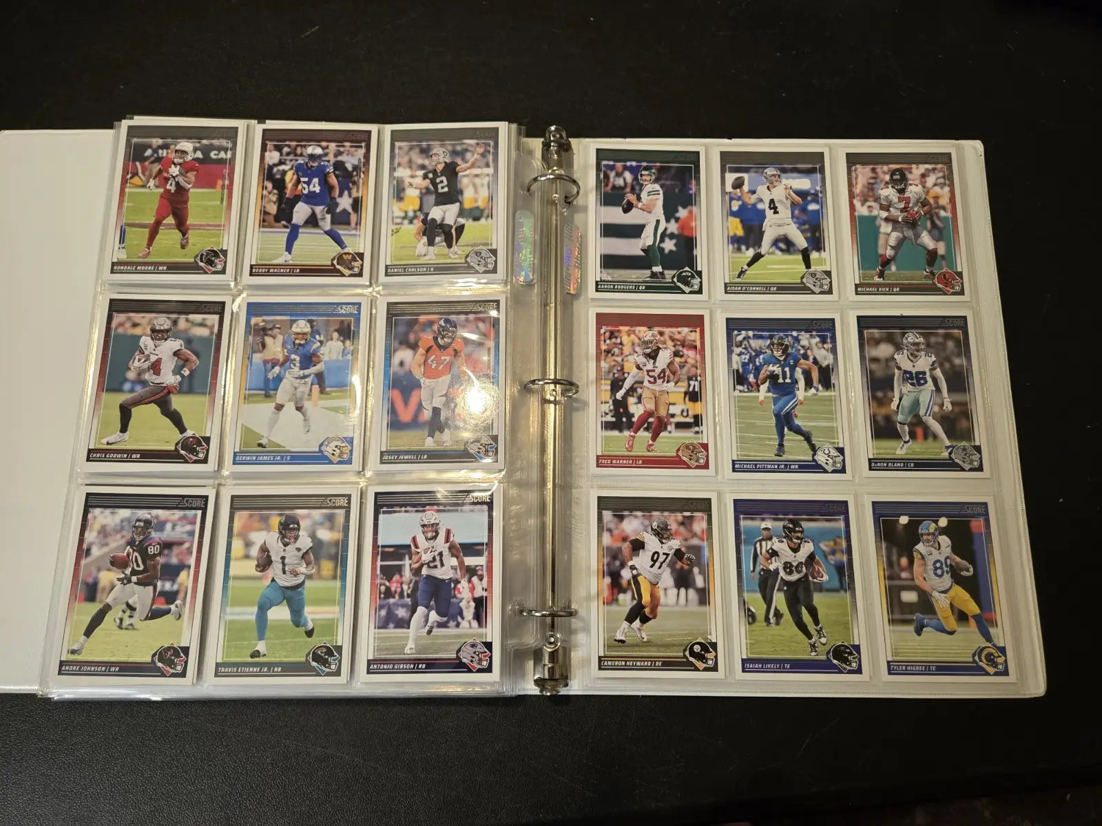 Score Football binder with multiple pages displaying stars, legends, and trading cards