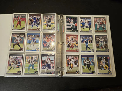 Score Football binder with multiple pages displaying stars, legends, and trading cards