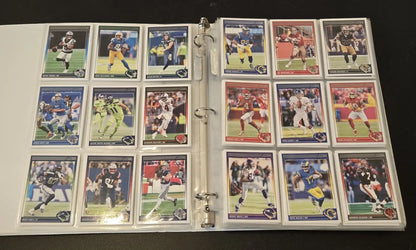 Binder of collectible Score Football cards with stars, legends, and base cards in a 2024 album