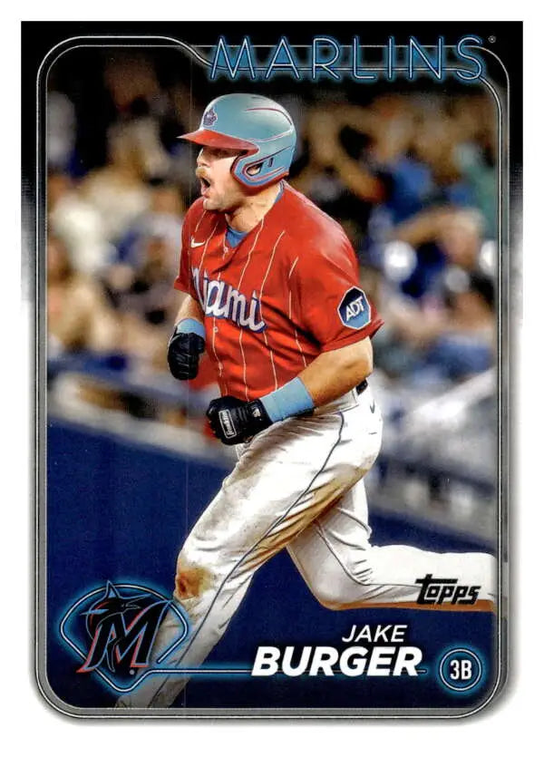 Baseball card of Jake Burger running the bases for the Miami Marlins in red jersey