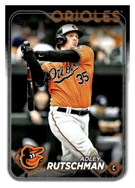 Baseball player in an orange Baltimore Orioles jersey swinging bat on Adley Rutschman card