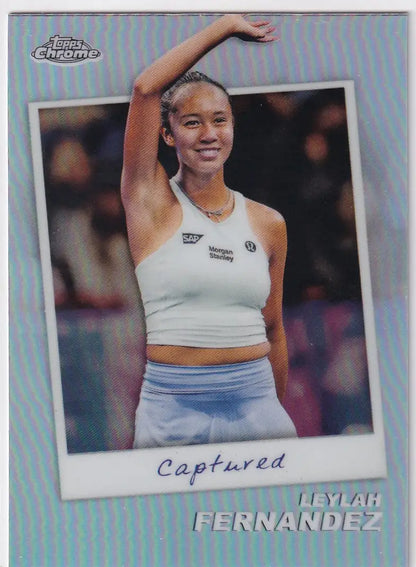 Tennis player in white crop top and blue skirt raising arm, Topps Chrome Captured image