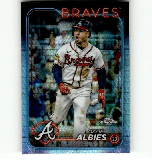 Ozzie Albies celebrating in white uniform on Topps Chrome Refractor Prism baseball card
