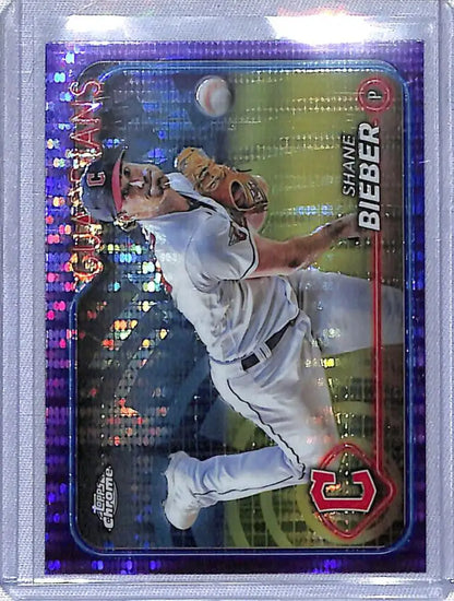 Shane Bieber making a throwing motion on a Sonar Purple baseball card