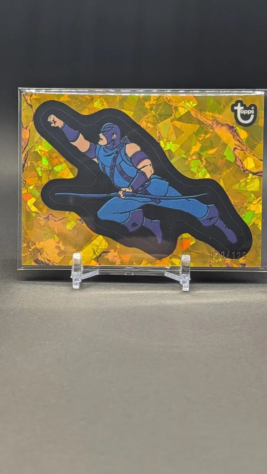 Holographic trading card featuring a blue ninja from Marvel Comic Book Heroes 2025