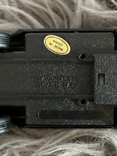 Underside of black diecast car from a car collection, showing MADE IN CHINA sticker