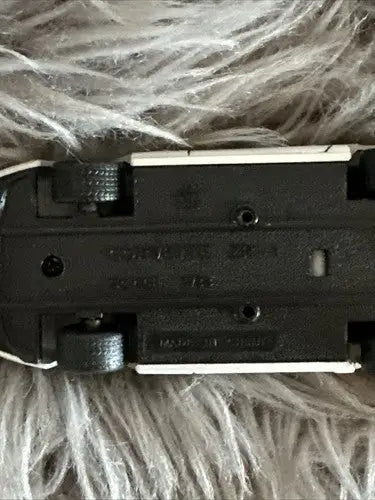 Black plastic base of diecast car from Corvette diecast car collection with visible wheels