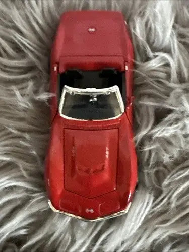 Red classic convertible sports car toy from diecast car collection featuring Corvette models