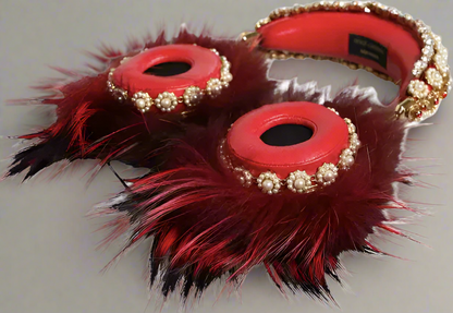 Red hair accessories with feathers and gold embellishments on a white background
