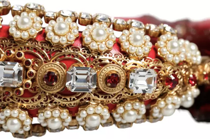 Decorative bracelet with gold, red, and pearl elements on a white background