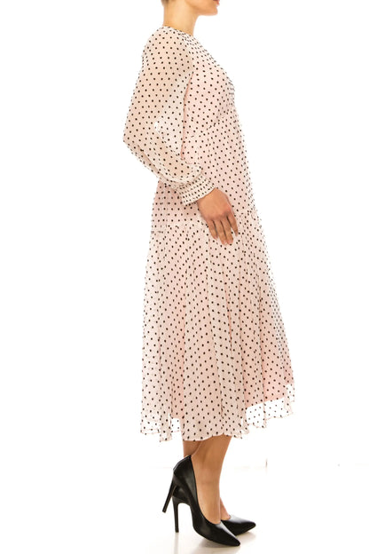 Polka dot midi dress with long sleeves and black heels from Maison Tara empire drop collection