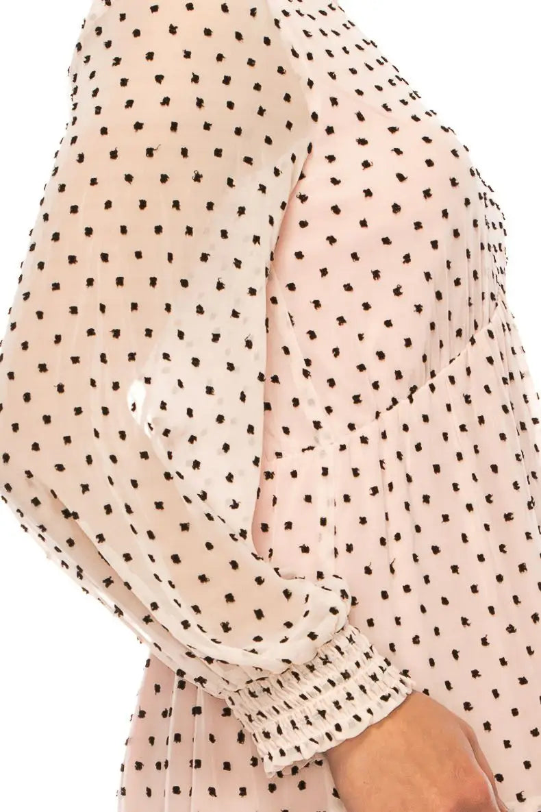 Light pink long-sleeved maison tara dress with black polka dots and shirred cuffs