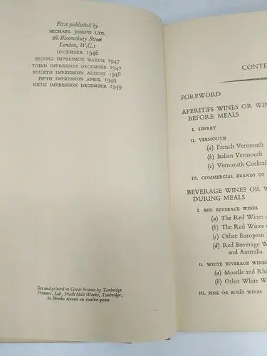 Open book with text from A Wine Primer by Andre L. Simon on store shelf pulls