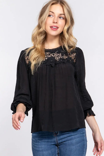 Black long-sleeved blouse with crochet lace panel and lace panel flounce detailing