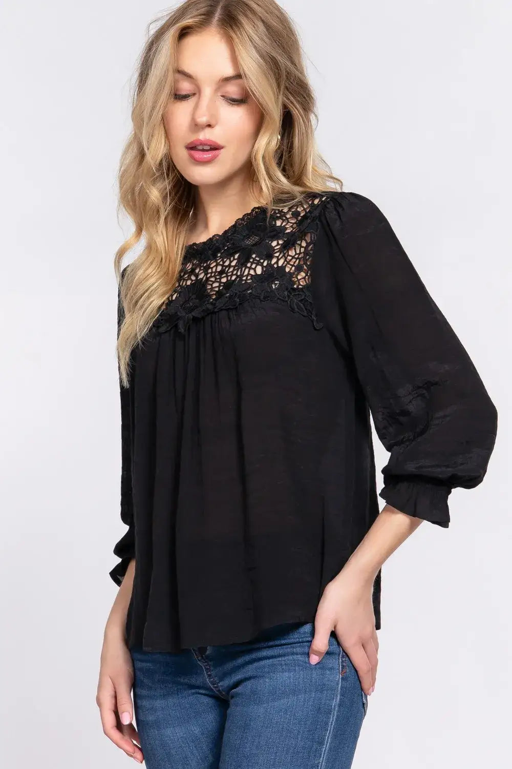 Women’s black long-sleeve blouse with crochet lace panel and lace panel flounce