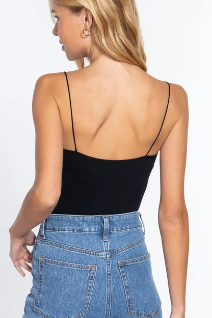 Black ribbed round neck spaghetti strap tank top paired with blue high-waisted denim jeans