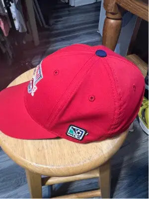 Red Bull baseball cap featuring a blue button and embroidered logo on the side