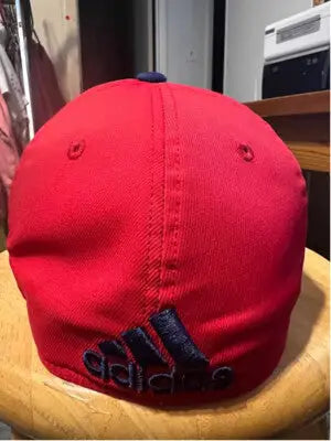 Red Bull baseball cap with dark blue Adidas logo embroidered on the back