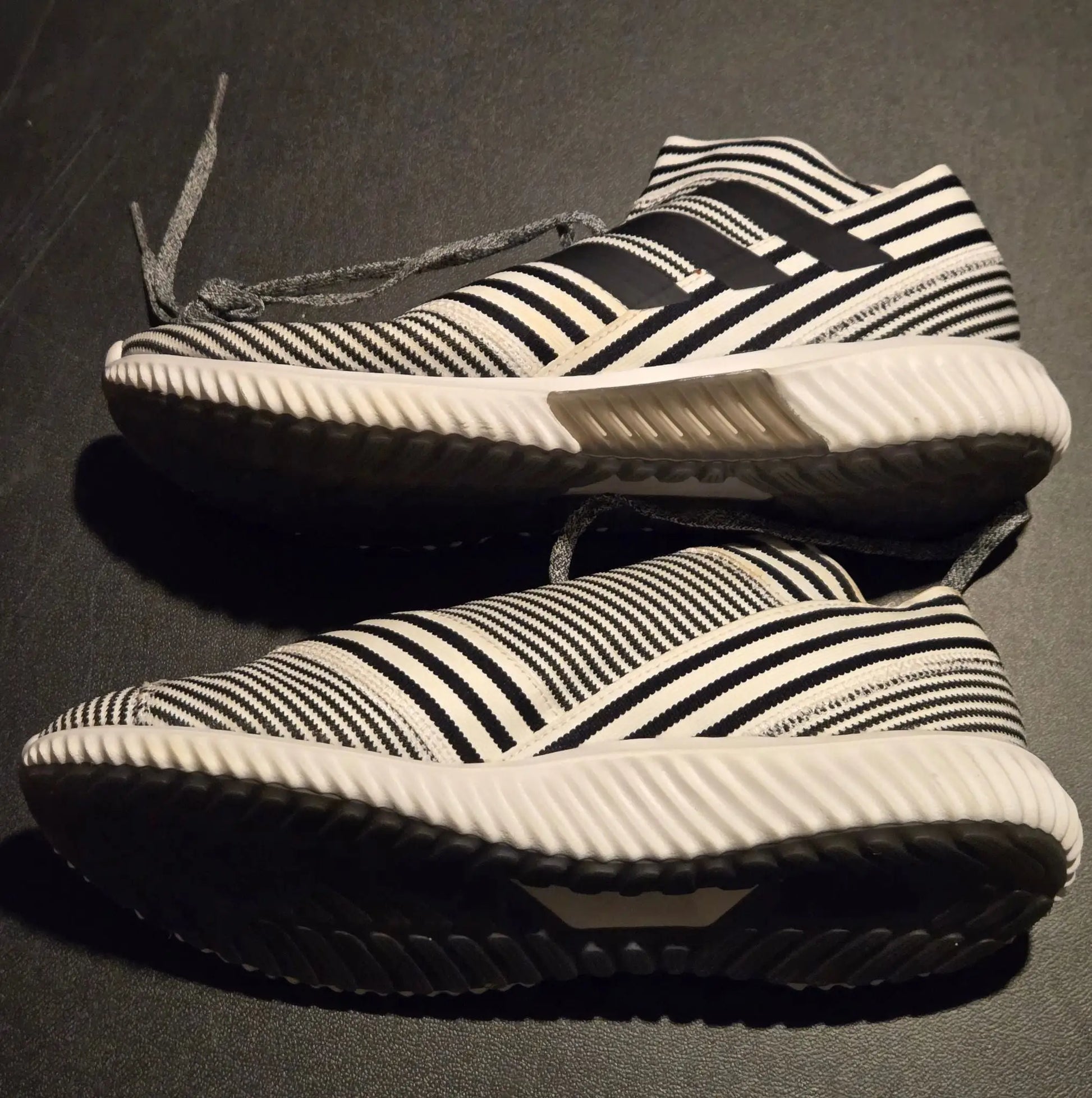 Black and white striped Adidas Sneakers Mens 9 with slip-on knit design and white soles
