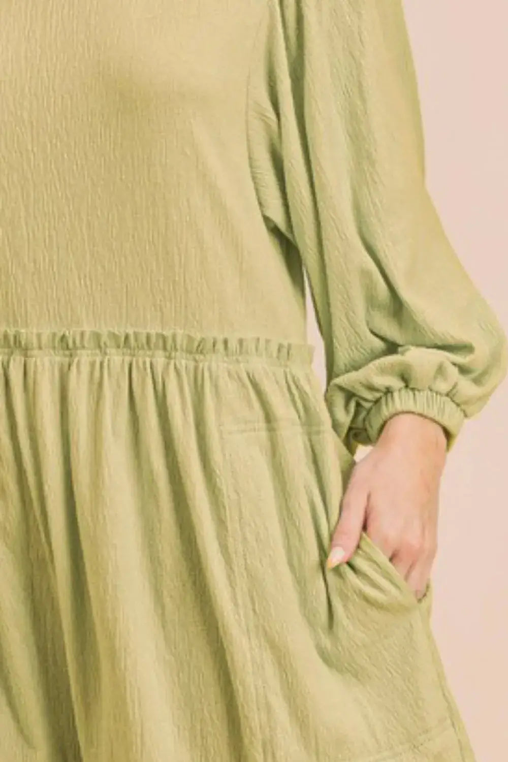 Olive green textured romper with frill round neck, long balloon sleeves, and elastic waistband
