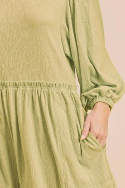 Olive green textured romper with frill round neck, long balloon sleeves, and elastic waistband