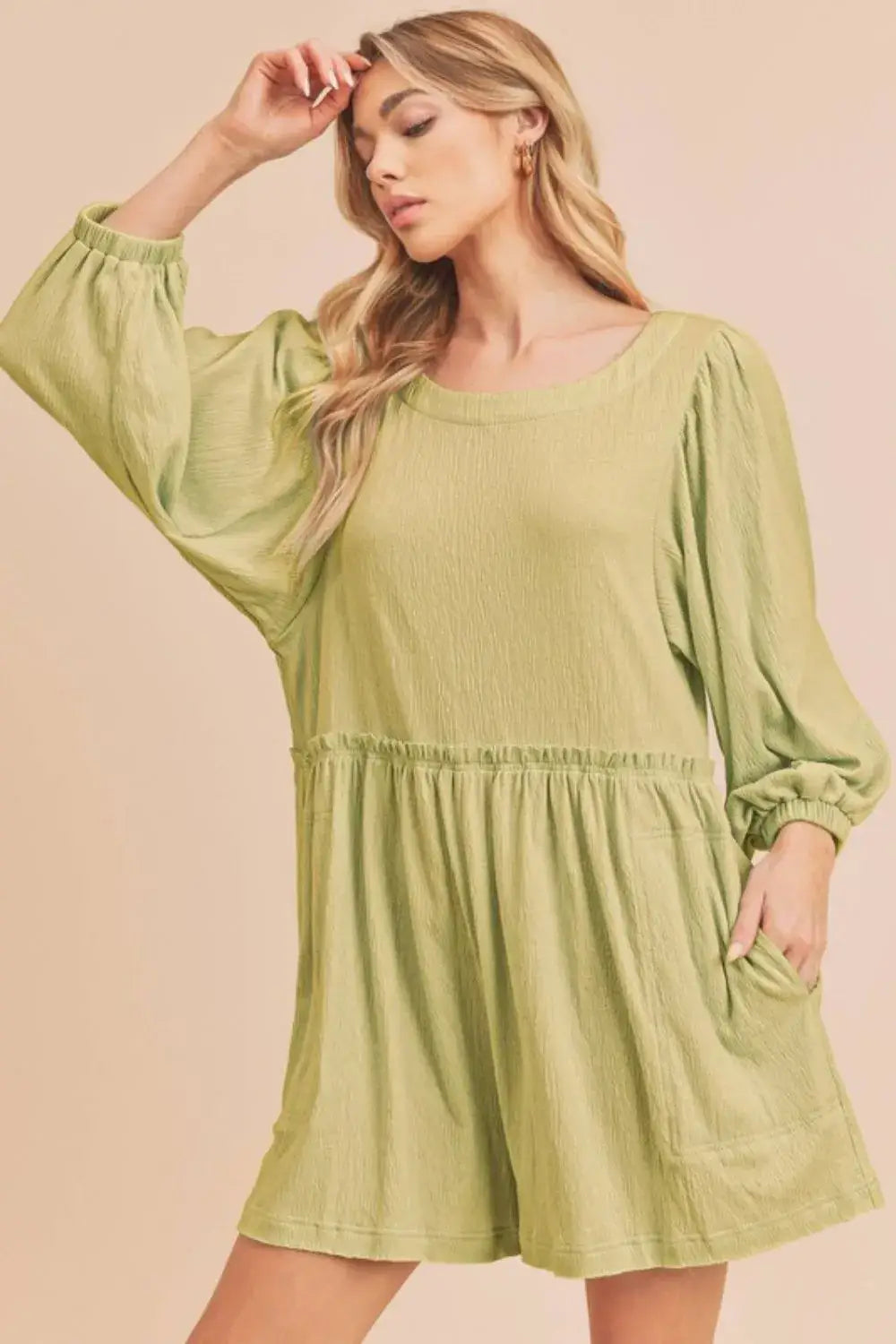 Olive green linen romper with puff sleeves, elastic waistband, and frill round neck