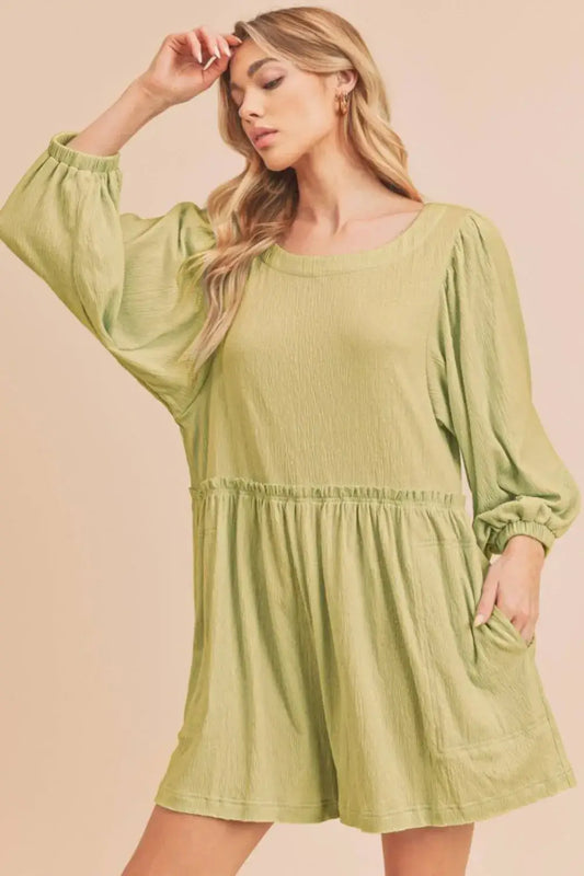 Olive green linen romper with puff sleeves, elastic waistband, and frill round neck
