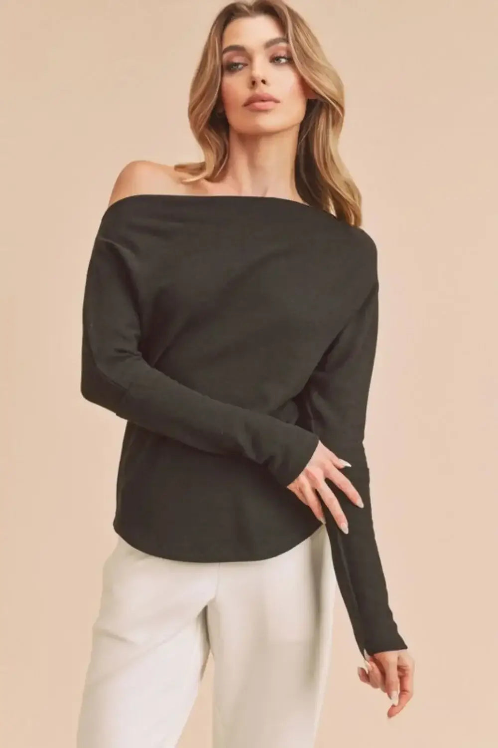 Black off-the-shoulder long sleeve knit top from Aemi + Co with a relaxed fit