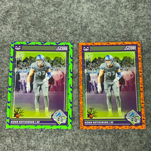 Halloween-themed Aidan Hutchinson football trading cards with green and orange borders