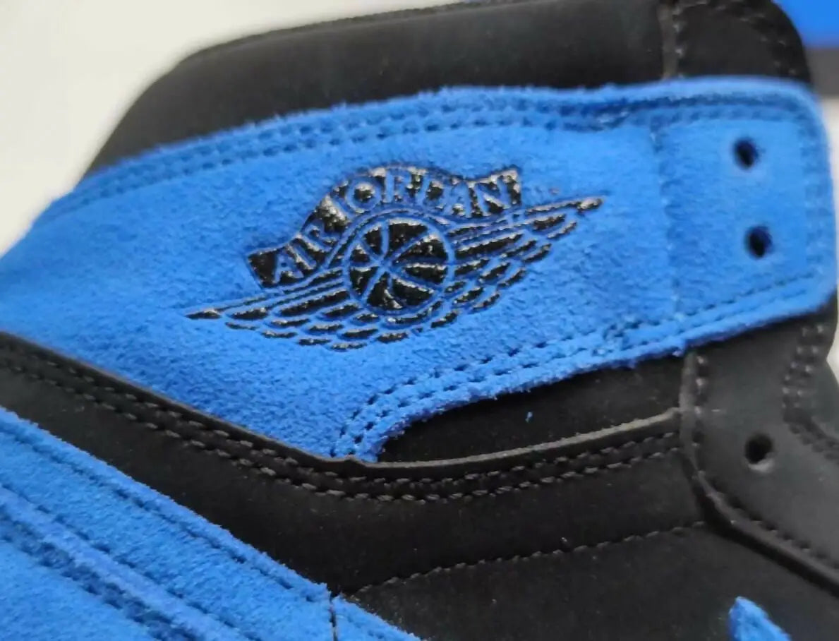 Black and blue suede Air Jordan 1 High OG Royal Blue sneaker with Winged Basketball logo, fast shipping