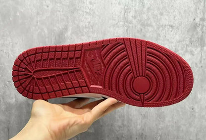 Red rubber outsole of Air Jordan 1 High OG Ruby sneaker with pivot circle and traction patterns for fast shipping