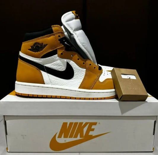 White and gold Air Jordan 1 High sneaker with black accents, fast shipping available