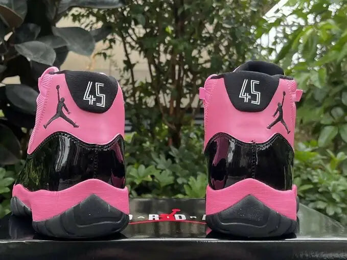 Pink and black Air Jordan 11 sneakers with fast shipping, available in business days