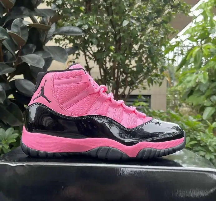 Vibrant pink and black Air Jordan 11 Black Pink high-top basketball shoe with patent leather accents for fast shipping