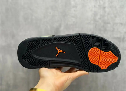 Black rubber sole with orange accents and Jumpman logo on Air Jordan 4 Undefeated sneaker for fast shipping