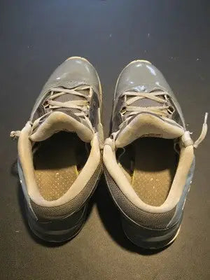 Well-worn Air Jordan Flight Cool Grey athletic shoes with white laces and insoles