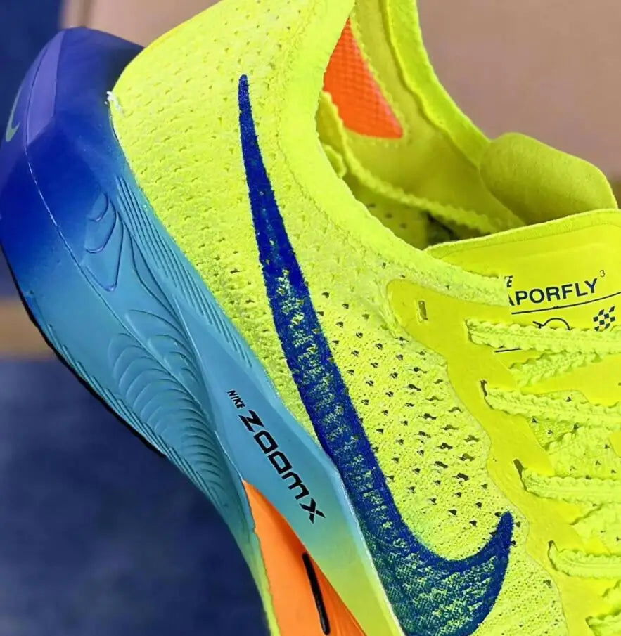Bright neon yellow Air Zoom Alphafly Next Vaporfly 3 running shoe with blue sole and orange accent for fast shipping