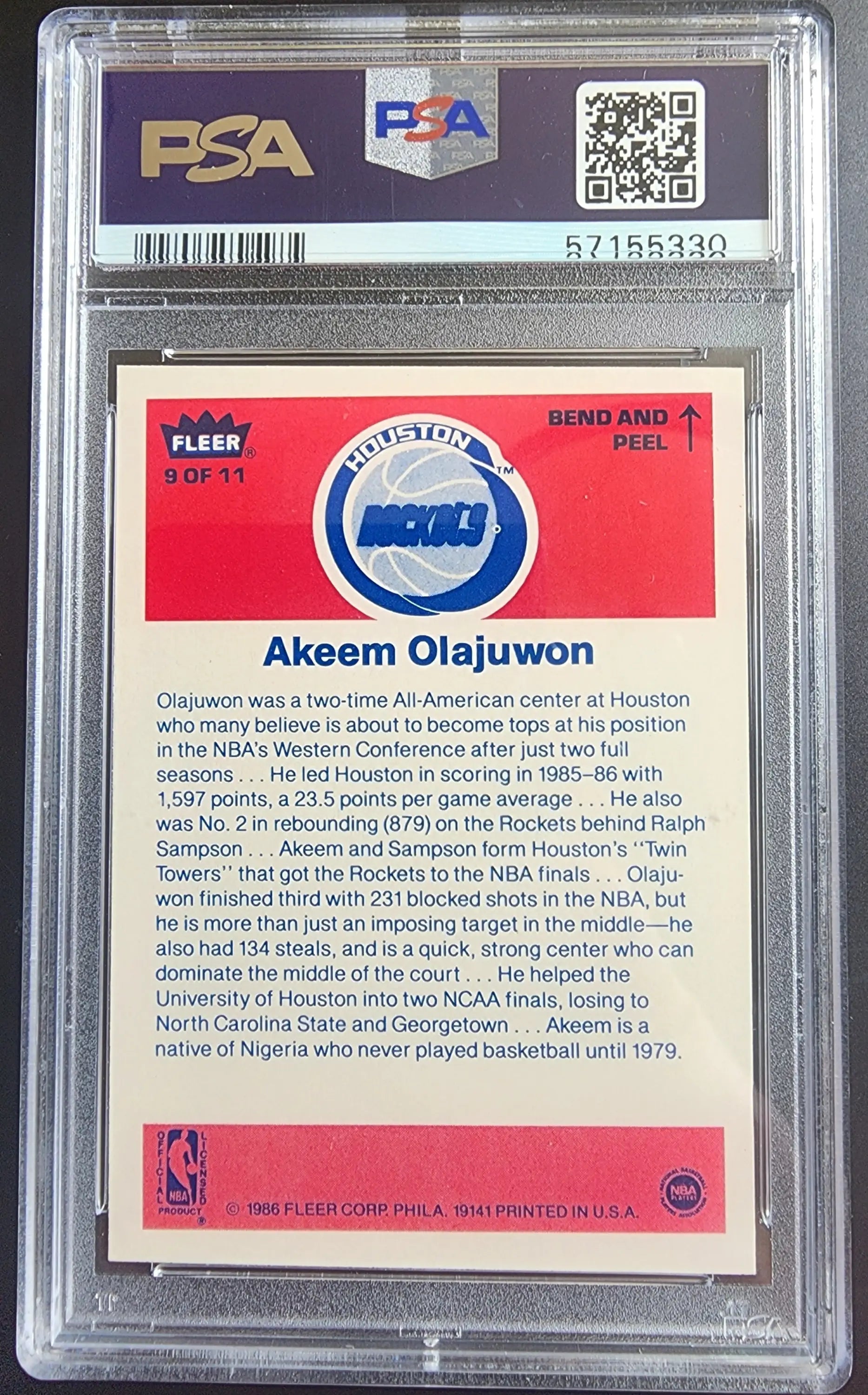 PSA-graded Akeem Olajuwon 1986 Fleer Stickers #8 trading card with red background