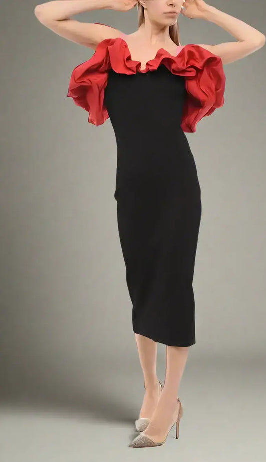 Woman wearing Alexander McQueen knitted black midi dress with red off-the-shoulder ruffle top