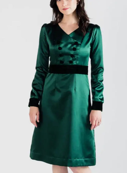 Woman modeling dark green poly satin Paris Bloom Noel uniformed party dress with velvet accents