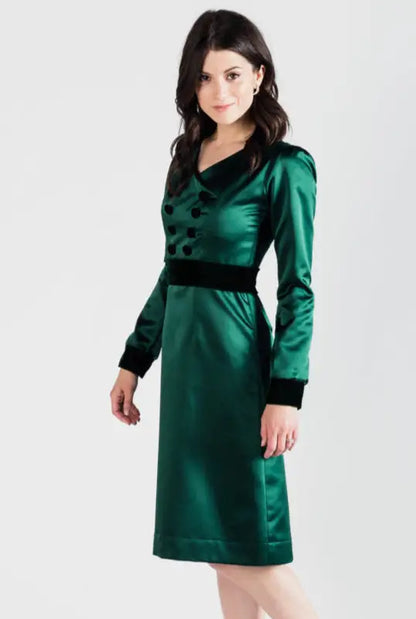 Woman modeling dark green poly satin Paris Bloom Noel uniformed party dress with velvet details