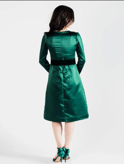 Emerald green poly satin midi dress with black velvet waistband by Paris Bloom Noel