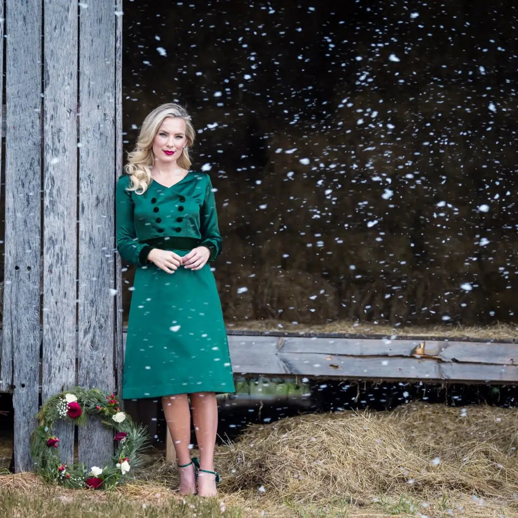 Woman modeling green velvet long-sleeve dress from Paris Bloom Noel holiday collection