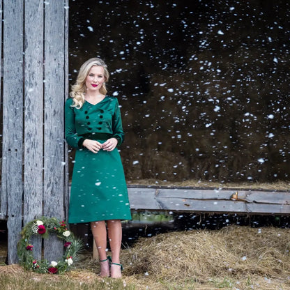 Woman modeling green velvet long-sleeve dress from Paris Bloom Noel holiday collection