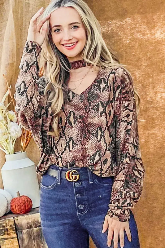 Women’s long-sleeve snake print top with choker neck and dolman sleeves