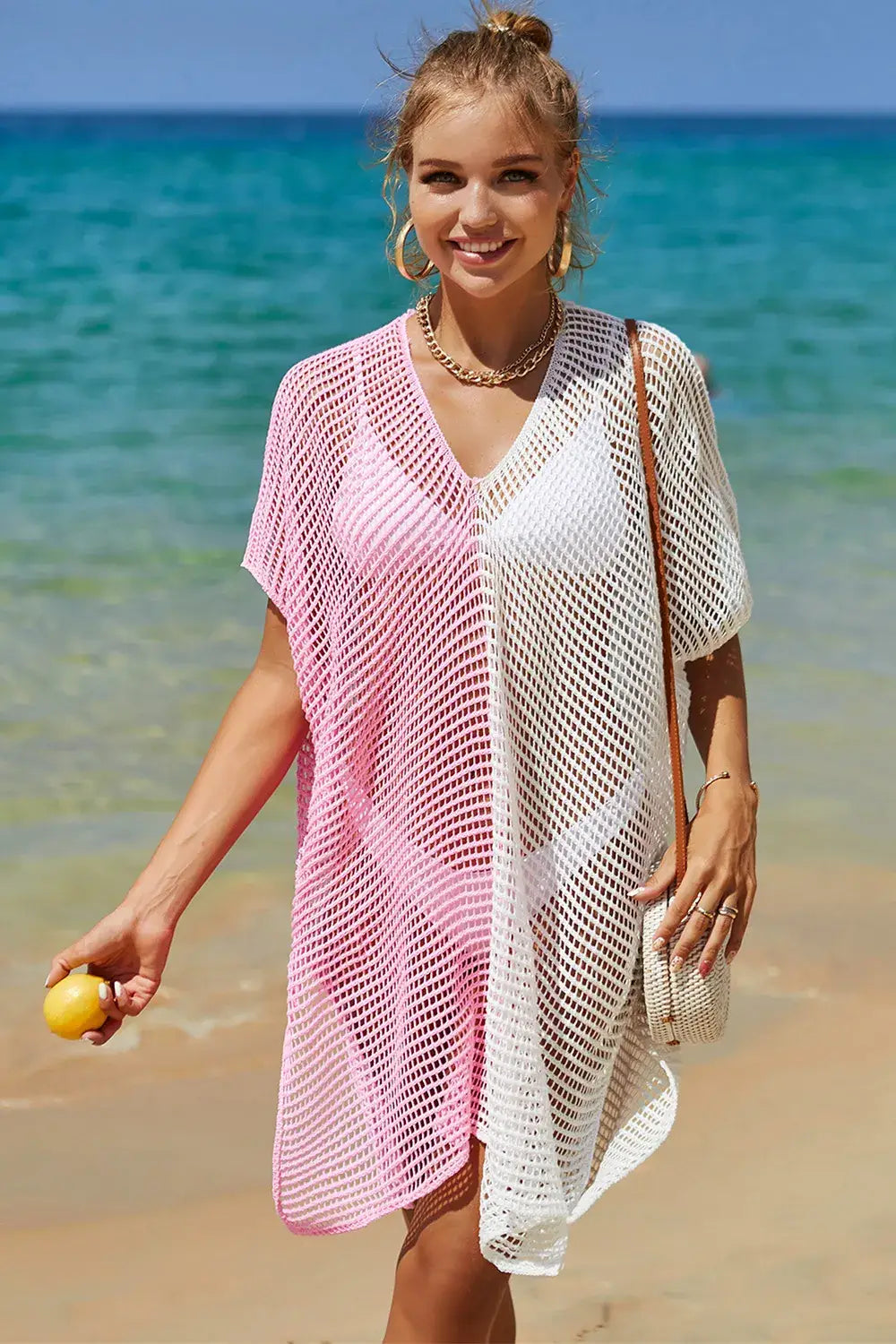 Woman in Angel Wings Openwork Contrast Slit Knit Cover Up over swimsuit at the beach